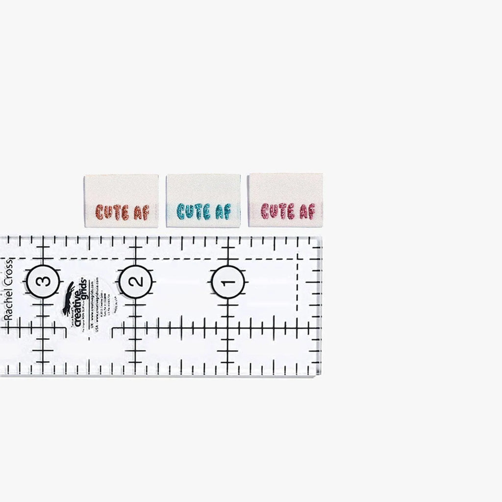 Cute AF! Woven Labels by KATM in vibrant colors next to a ruler.