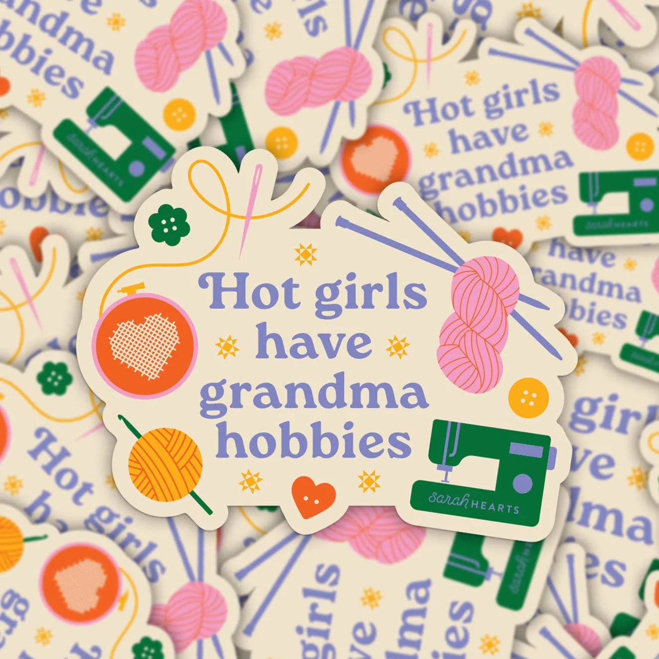 Sticker with 'Hot girls have grandma hobbies' text surrounded by colorful graphics on a patterned background.