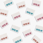 Cute AF! Woven Labels by KATM in colorful embroidered text.