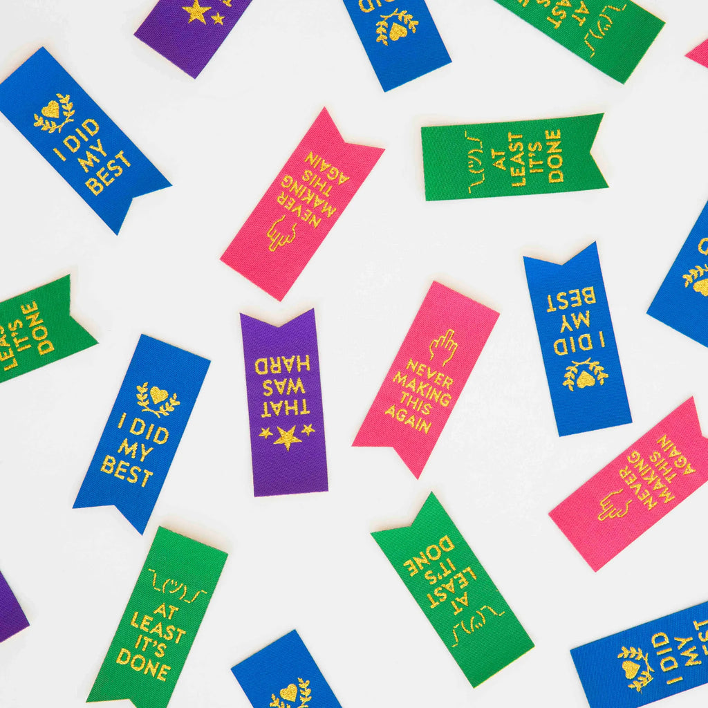Colorful woven sew in labels  with motivational text on a white background  by Sarah Hearts
