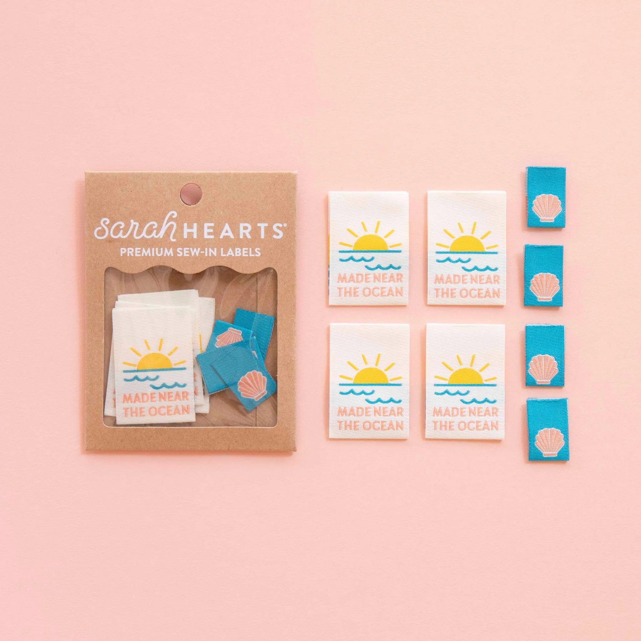 Packaging of Sarah Hearts premium sew-in labels on a pink background