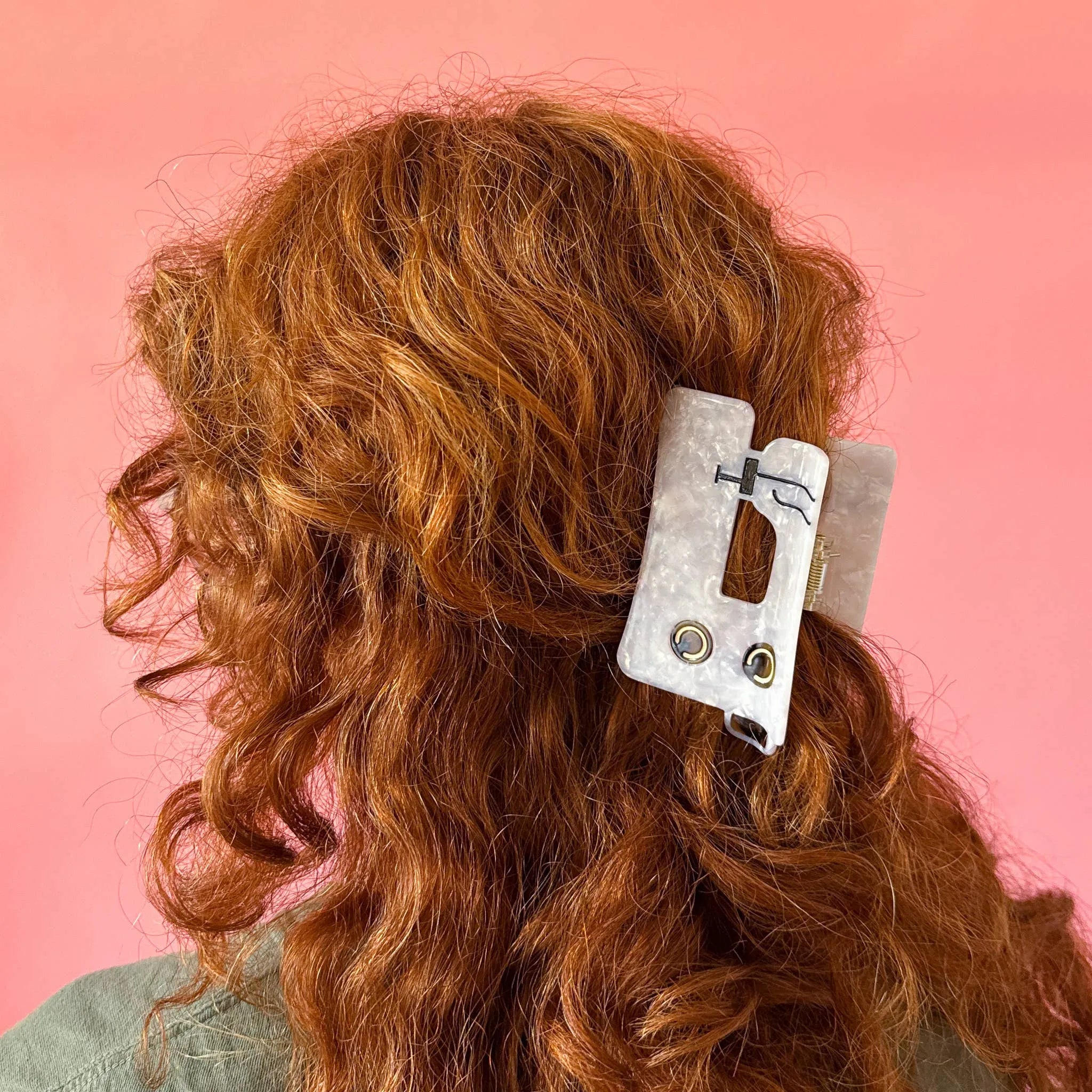 Person with wavy red hair wearing a sewing machine hair clip from Sarah Hearts