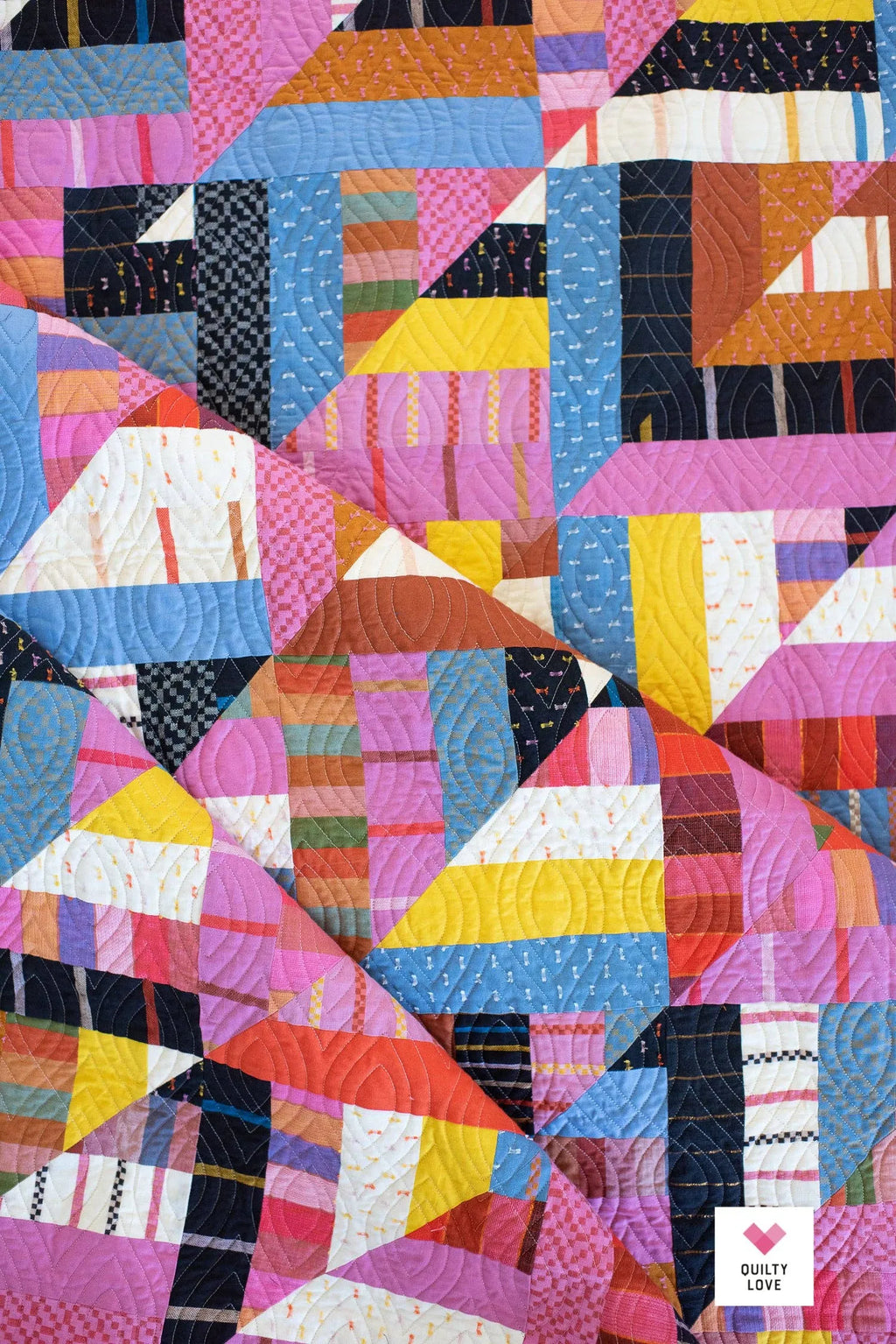 Colorful quilt with geometric pattern on a white background Lucky Log Cabin by Quilty Love