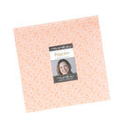 Popcorn by Elizabeth Hartman layer cake for Moda, a stack of 10-inch squares tied with a ruler ribbon, with a peach daisy print on top.