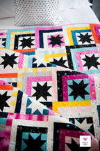 Lifestyle qilt shot of Log Cabin Stars by Quilty Love