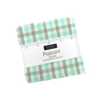 Popcorn Wovens charm pack by Elizabeth Hartman for Moda, a stack of 5-inch gingham squares with a paper wrapper.