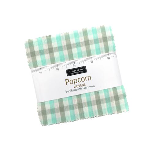 Popcorn Wovens charm pack by Elizabeth Hartman for Moda, a stack of 5-inch gingham squares with a paper wrapper.