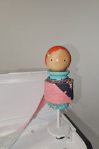 Binding Babies Annie on a sewing machine spool.