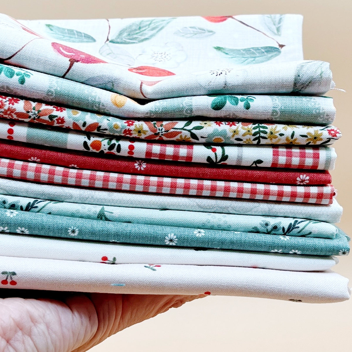 Cherry Orchard 11-piece fat quarter bundle by Bernadett Urbanovics for FIGO Fabrics featuring vintage cherries, florals, gingham and coordinating quilting prints