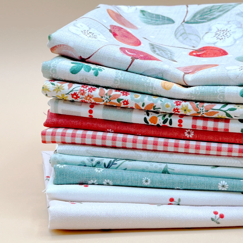 Cherry Orchard 11-piece fat quarter bundle by Bernadett Urbanovics for FIGO Fabrics featuring vintage cherries, florals, gingham and coordinating quilting prints