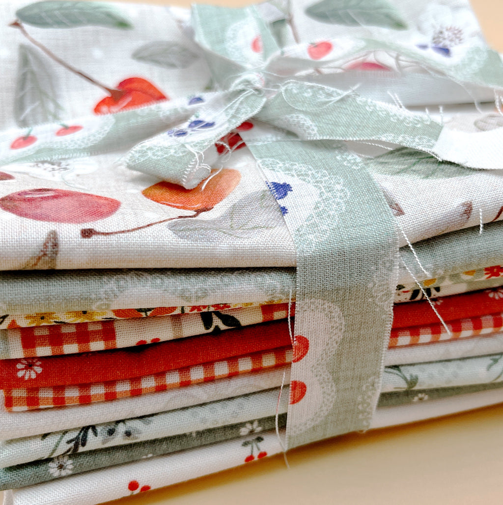 Cherry Orchard 11-piece fat quarter bundle by Bernadett Urbanovics for FIGO Fabrics featuring vintage cherries, florals, gingham and coordinating quilting prints