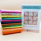 Quilt Kit with Stack of colorful fabrics from the Ghostly Garden Collection with a quilt pattern book titled 'Walden Pond' by Eudaimonia Studio.