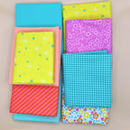 Collection of colorful fabric that are included in the ghostly garden Walden Pond Quilt Kit  
