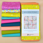 Stack of colorful fabric bundles included with a quilt pattern book titled 'Walden Pond' on a beige background.