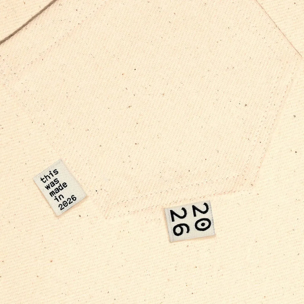 Circa 2026 Woven Labels by KATM on beige fabric.