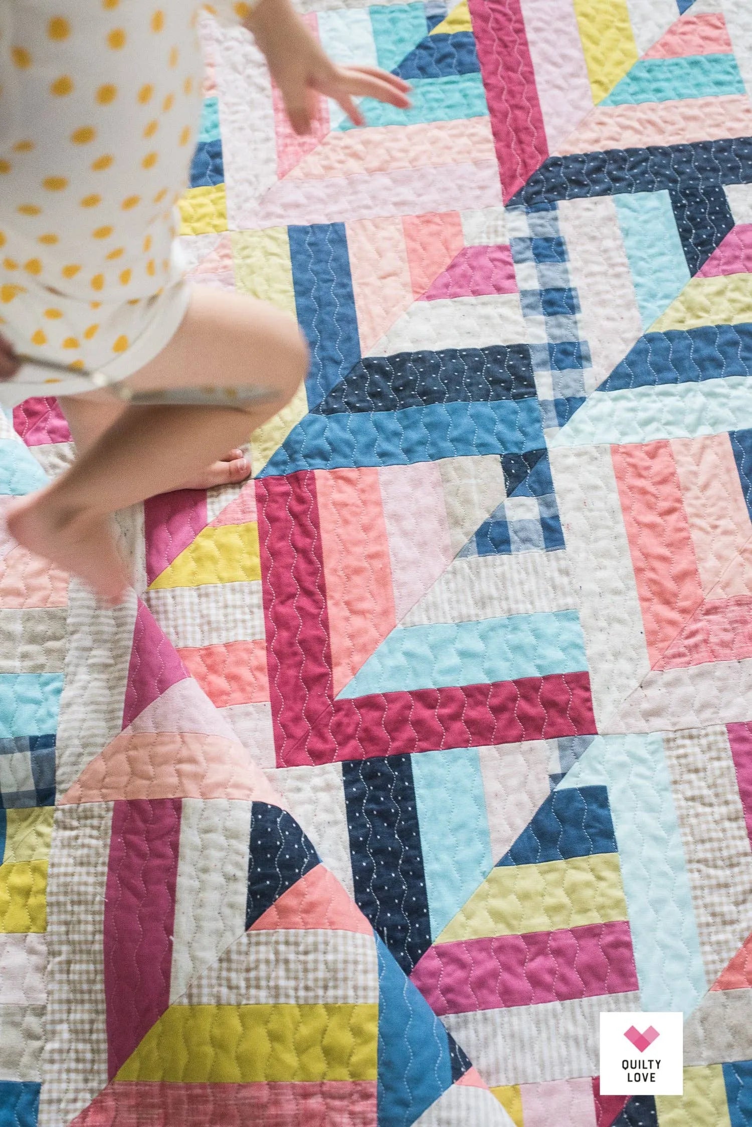 Colorful geometric quilt Lucky Log Cabin by Quilty Love