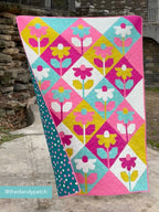 Colorful modern floral quilt pattern with bold floral blocks for confident beginners